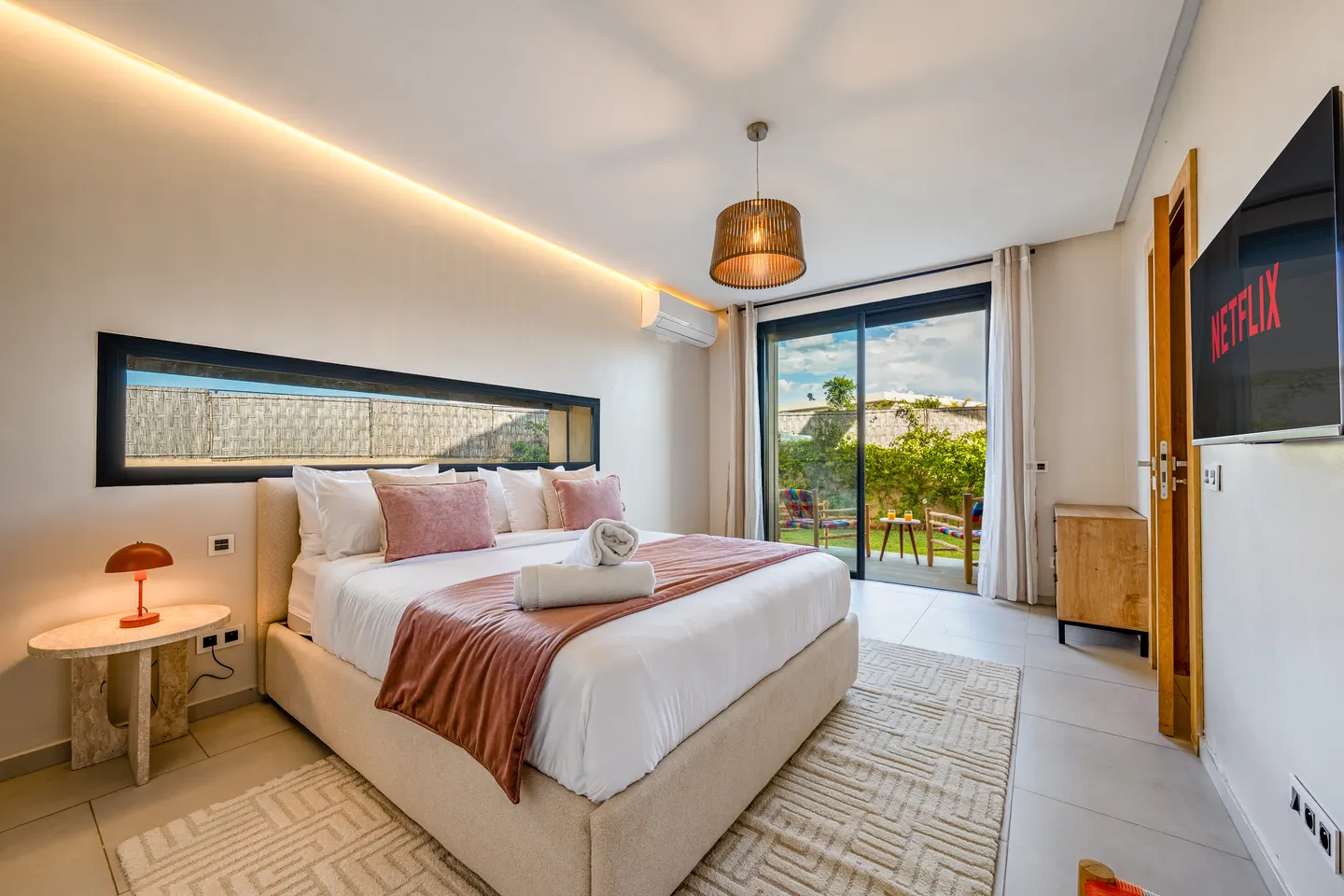 Bedroom 3, ground-floor suite: queen bed, air conditioning, door to its private terrace