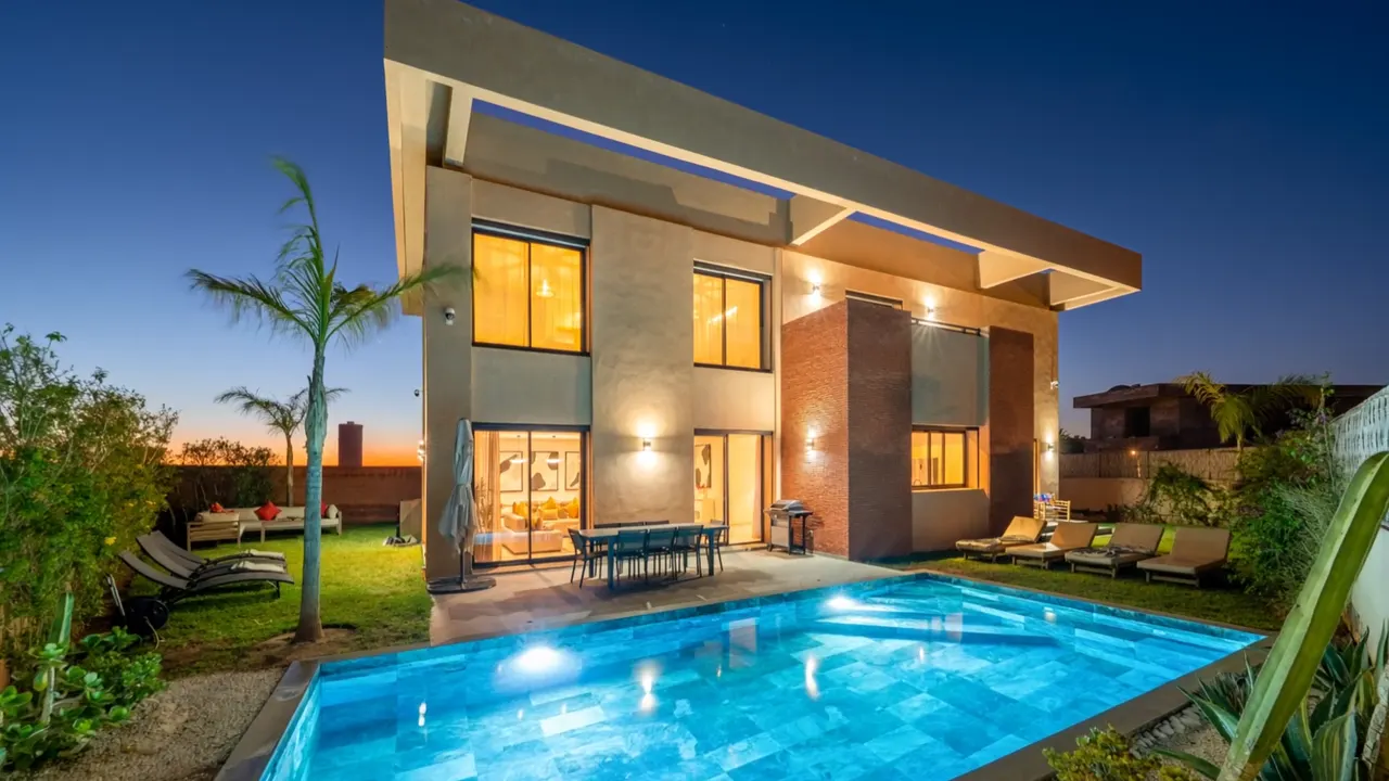 Villa Safira at dusk: lit facade and turquoise pool