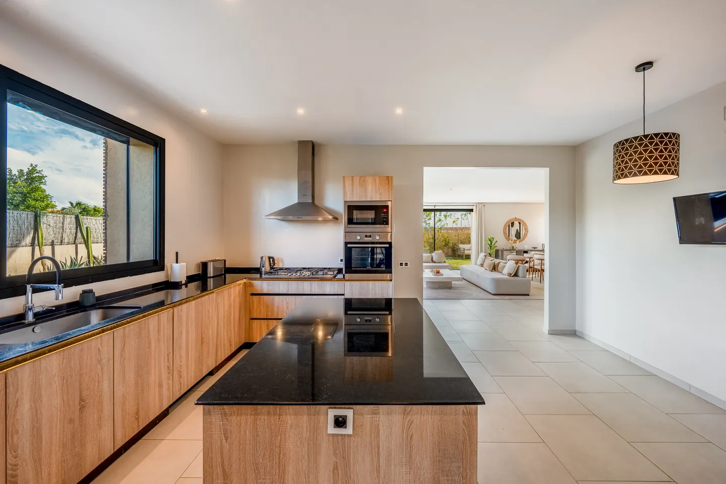 Kitchen island and appliances, living room beyond