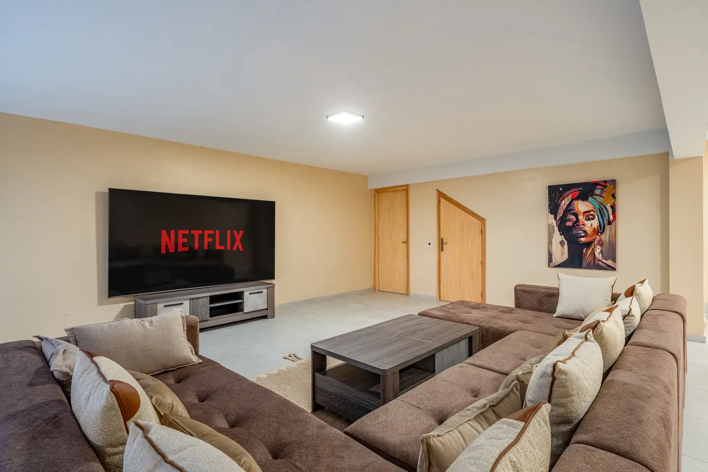 Private cinema corner with large sofa and screen