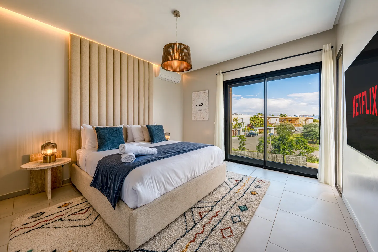 Bedroom 4, upstairs: queen bed, blue bedding, large window on the residence