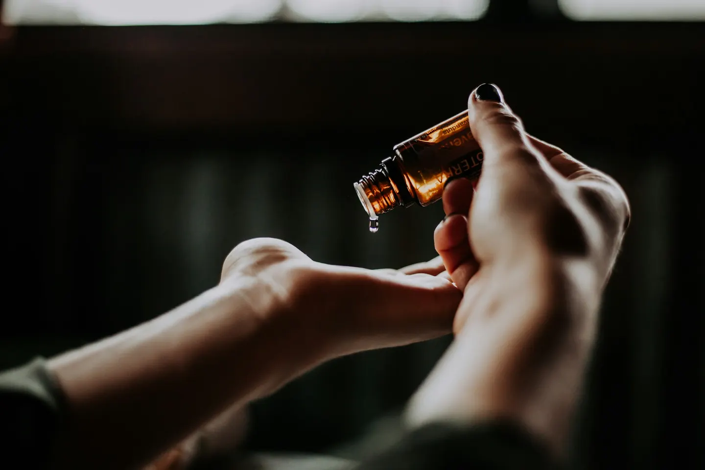 Huile de massage versée dans le creux de la main