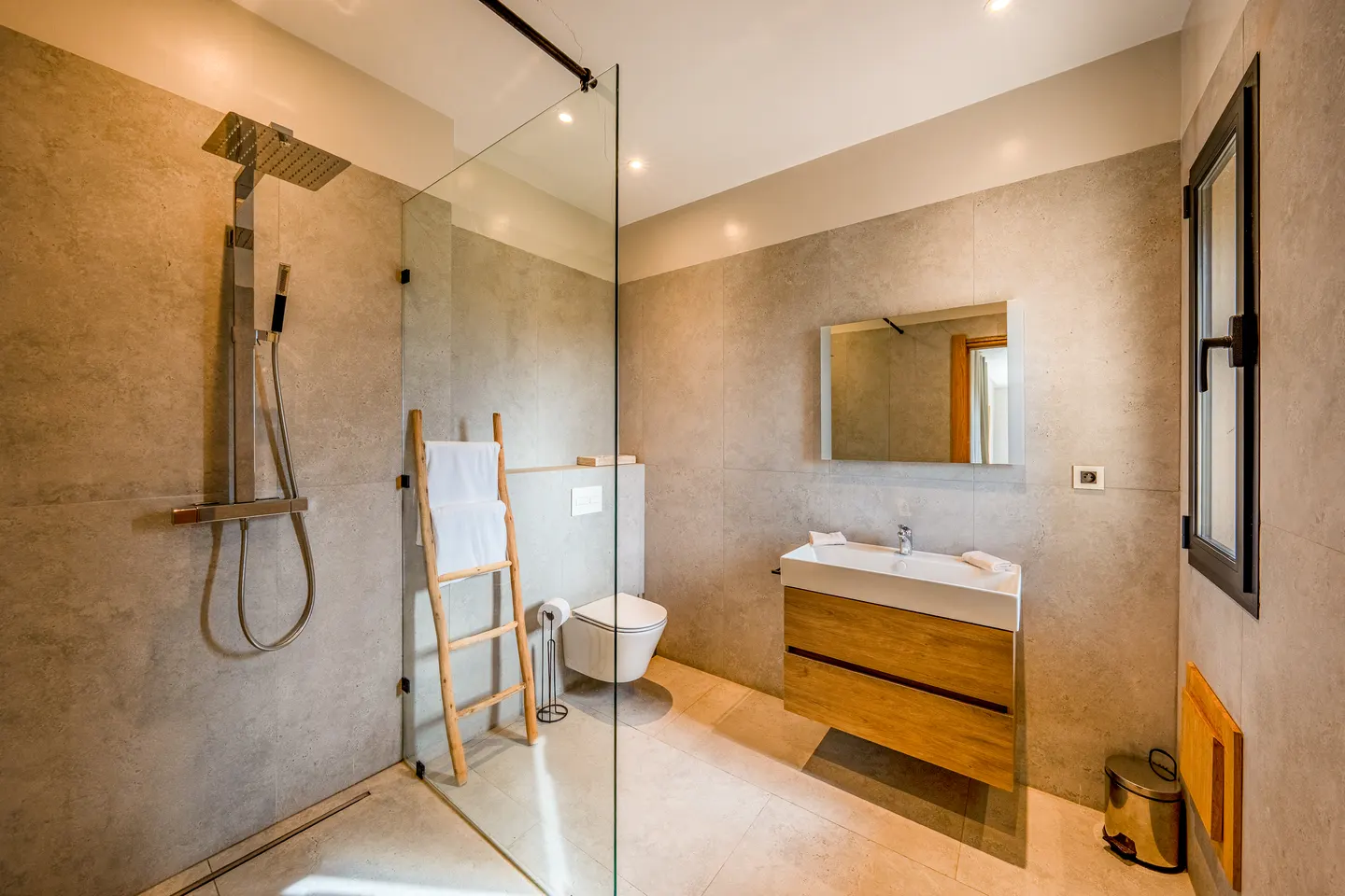 Bathroom with glass walk-in shower and wooden vanity